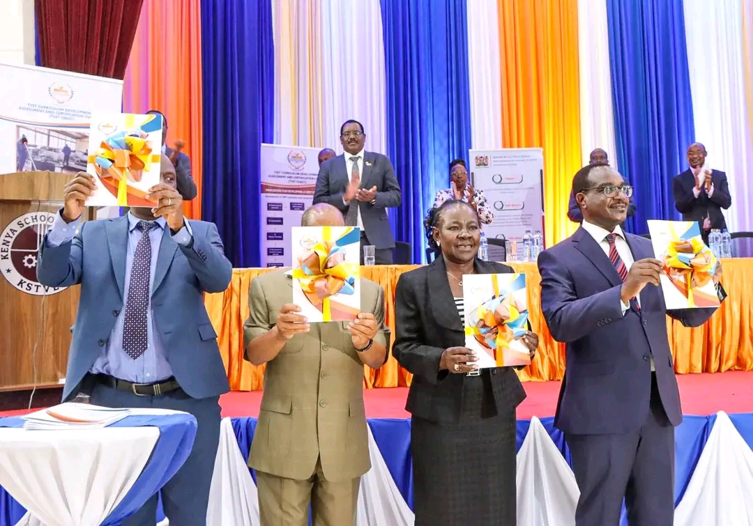 Education Cabinet Secretary Julius Ogamba on the right followed by Principal Secretary State Department for TVET Dr. Esther Muoria displaying TVET assessment results.