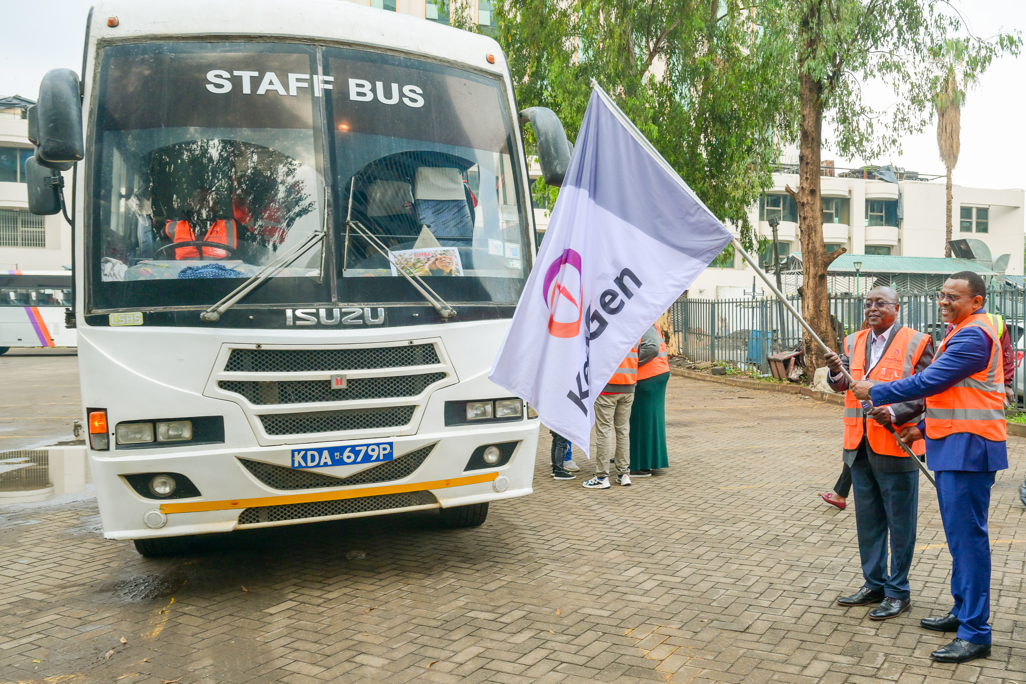 KenGen Managing Director and Chief Executive Officer, Eng. Peter Njenga (right)  f  lags off a vehicle carrying investors for a tour.