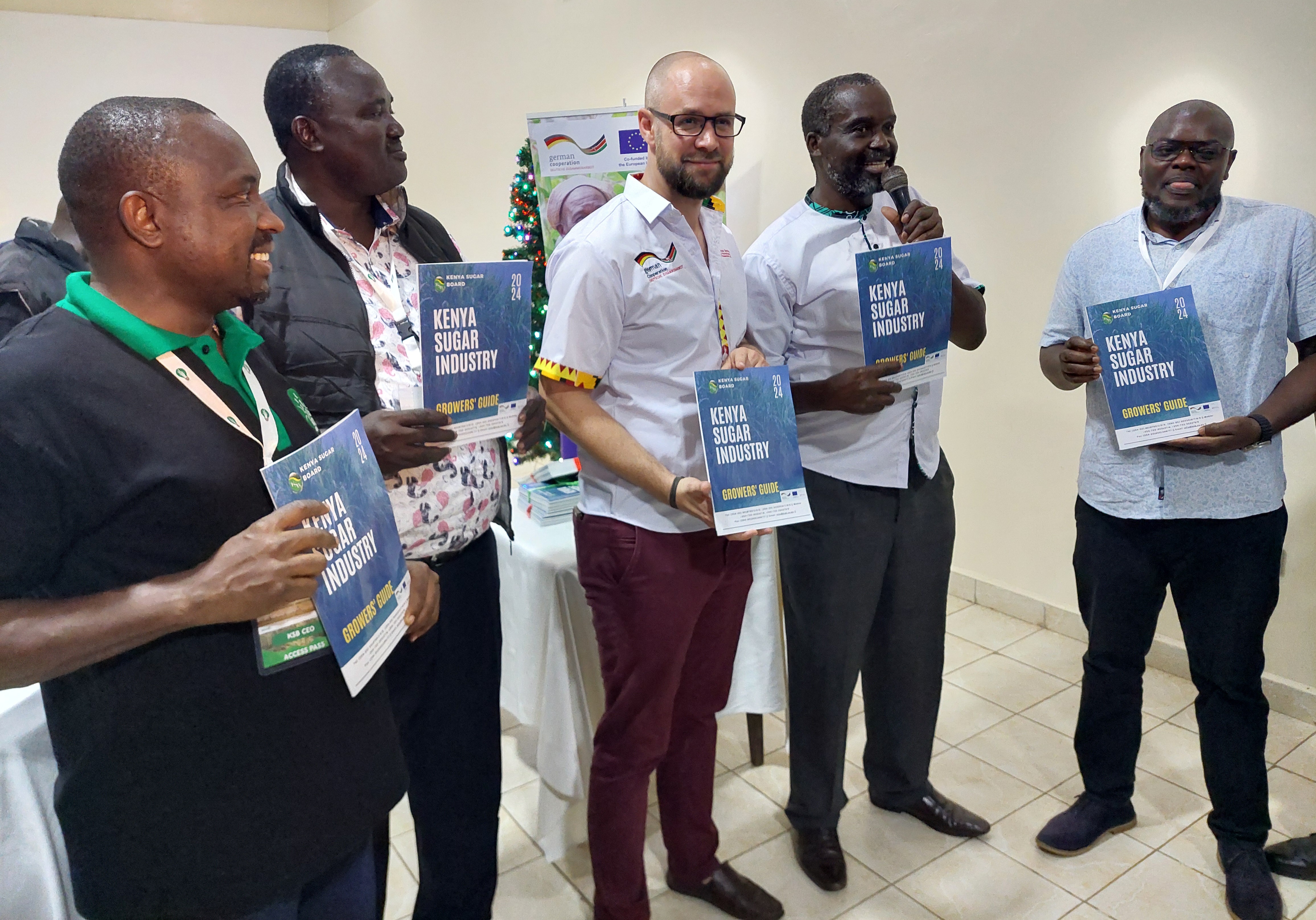 GIZ Project coordinator David Kersting (left) and Kenya Sugar Board Chairman Nicholas Gumbo (right) during the launch of the Kenya Sugar Industry Grower's Guide in Kisumu. Photo/Photo Chris Mahandara