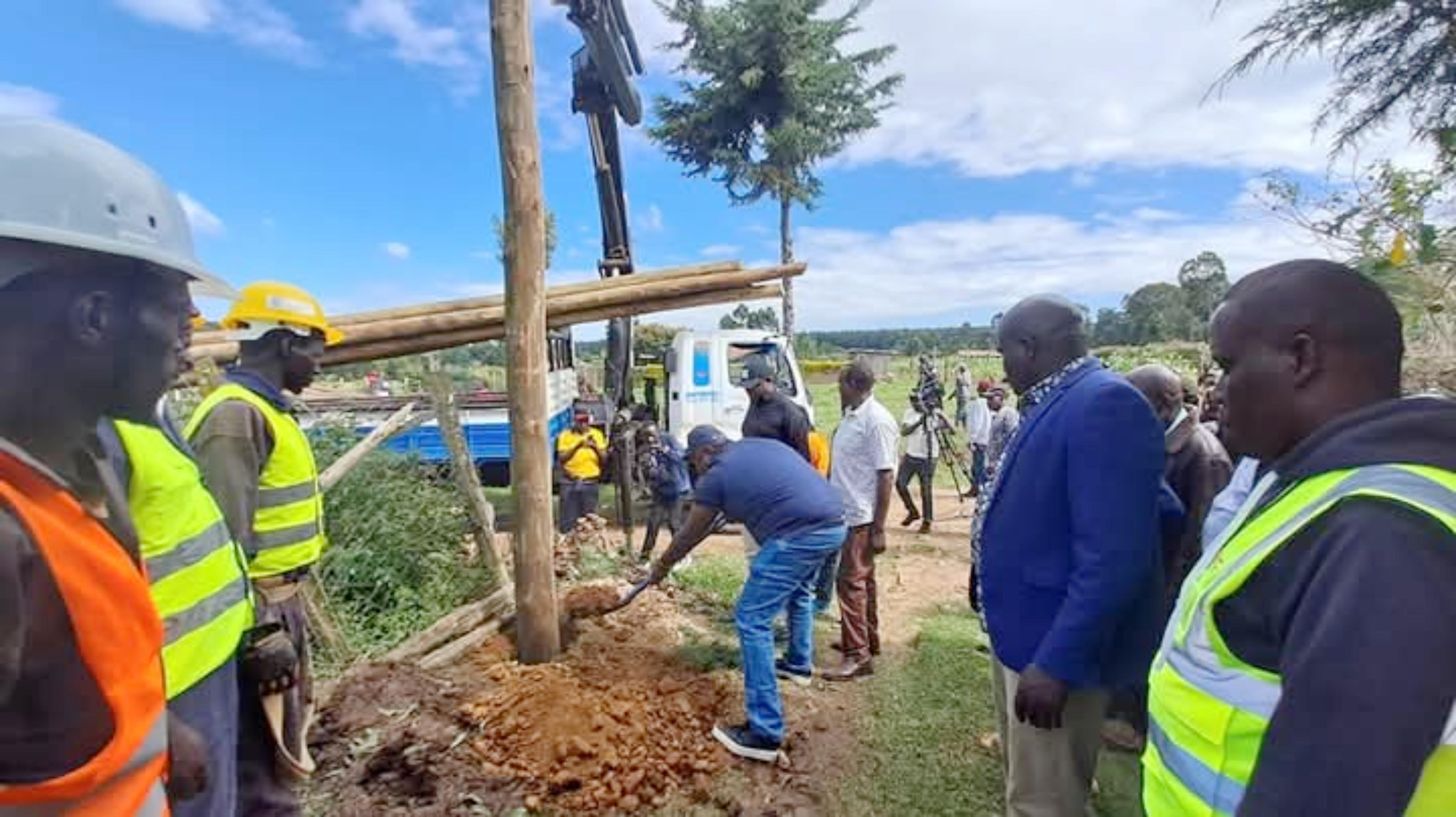 Principal Secretary in the State Department for Energy Alex Wachira (in jeans) installs a power pole in Gikamba sub-location Kieni Nyeri county where a total of 314 homes were connected with electricity.