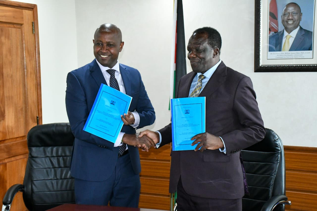 Ministry of Co-operatives and MSMEs Development Cabinet Secretary, Dr. Wycliffe Oparanya with Principal Secretary for Co-operatives, Patrick Kilemi shake hands holding the FY 2024/2025 Performance Contract for the Cooperatives Department after the signing. 