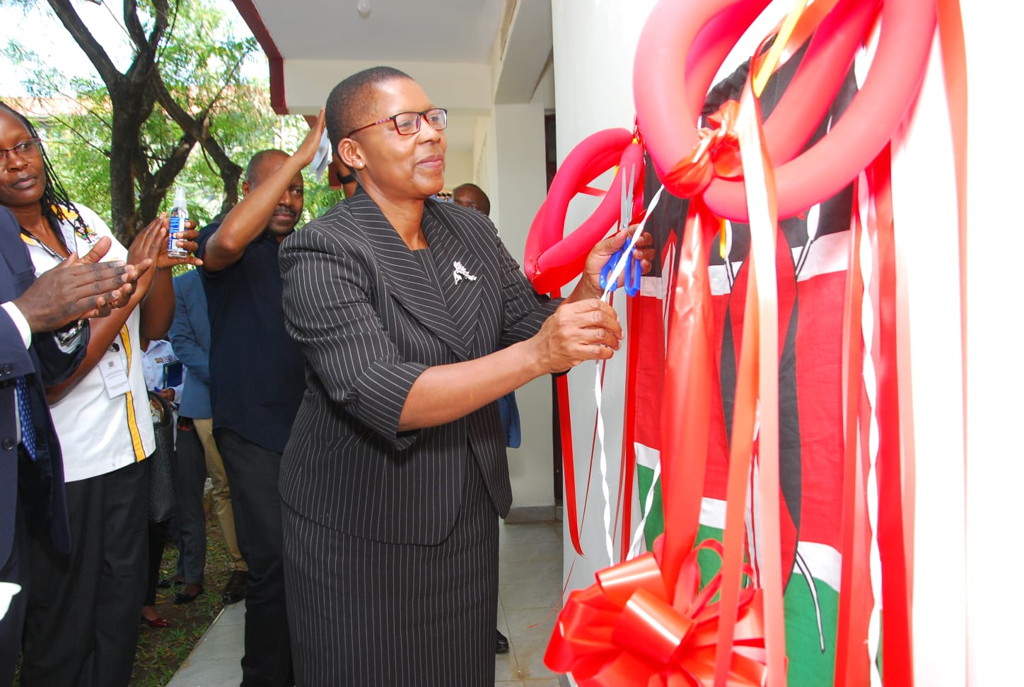 Attorney General Dorcas Oduor cuts the tape as she officially opens a regional documentation resource centre in Kisumu.