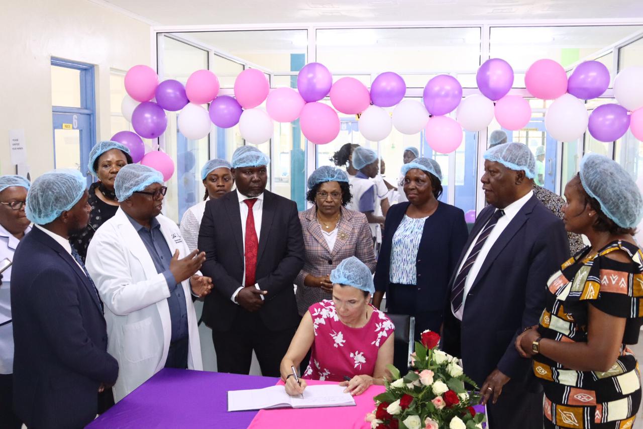 The President Catholic Medical Mission Board (CMMB), Madam Mary Beth Powers, while signing a visitor's book at Kitui county Referral hospital today during the inauguration of Maternal and Newborn Healthcare Unit at the hospital. Photos/Purity Mwendwa.