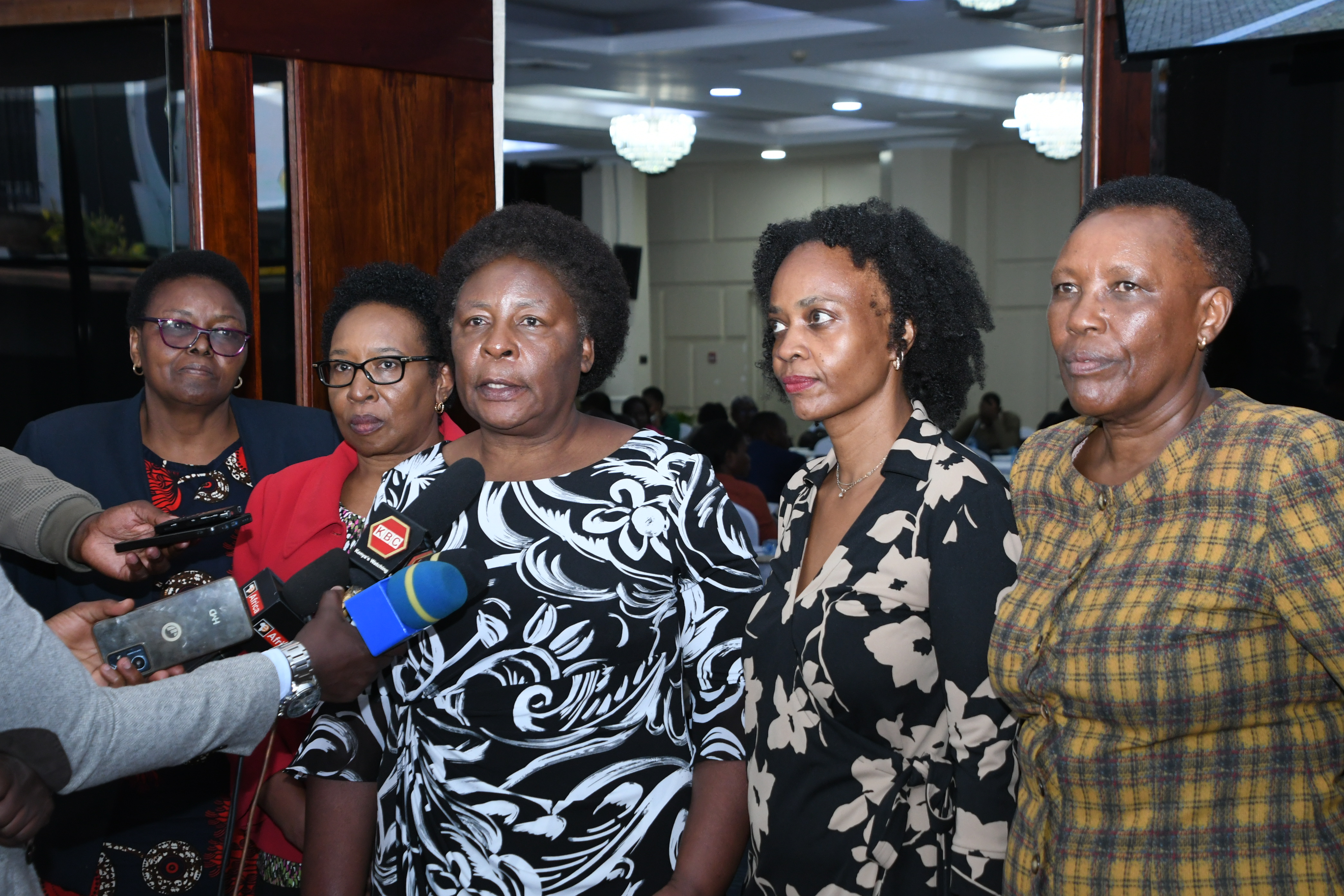 Chairperson of the Technical Working Group on Gender  Based Violence (GBV) Including Famicide, Nancy Baraza  (center) addresses members of the press at Kenyatta  International Convention Center, Nairobi during a Plenary  Meeting for Technical Working Group on Gender-Based  Violence (GBV) Including Femicide. PHOTOS BY BONFACE  MALINDA/KNA