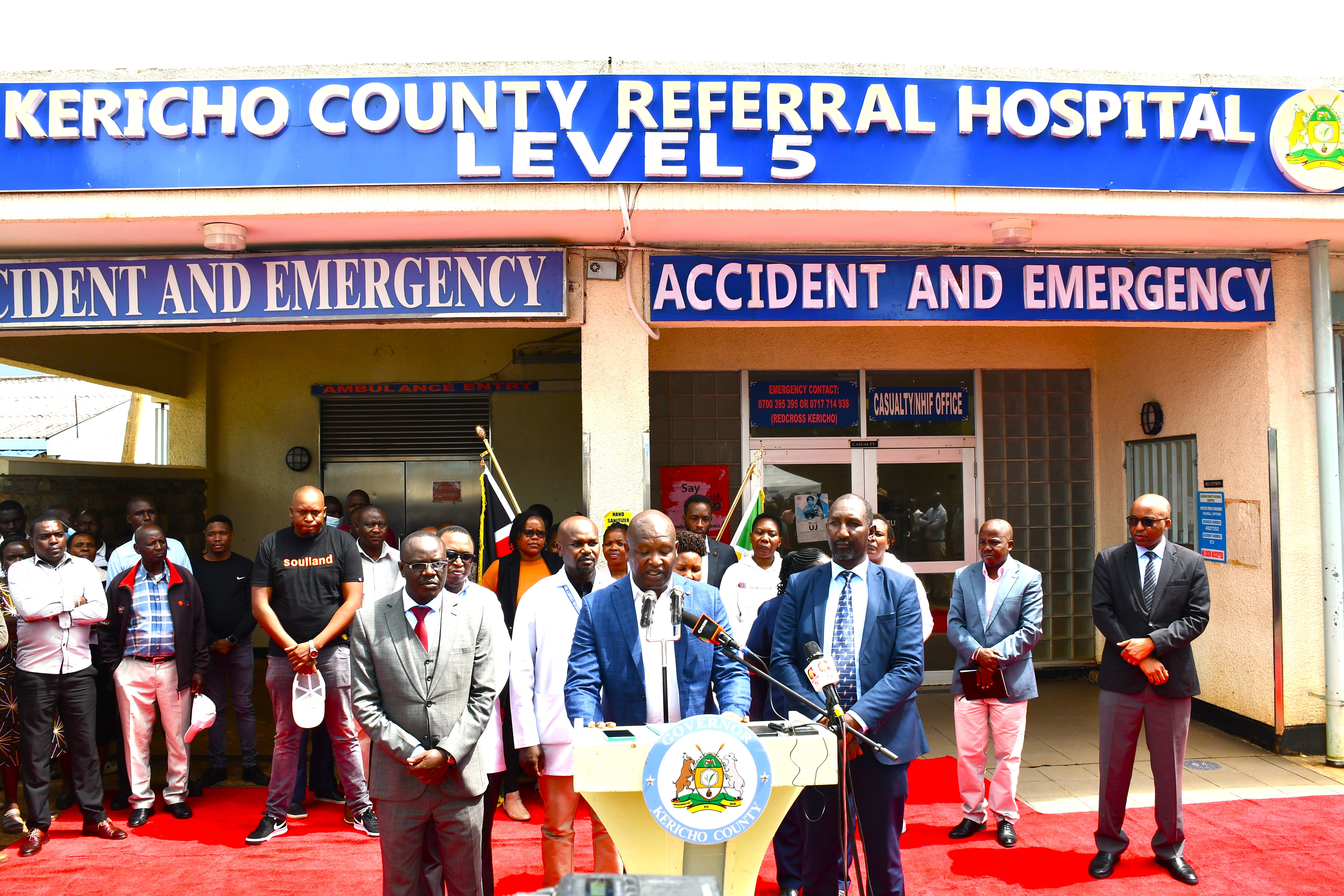 Kericho County Governor Dr. Eric Mutai during the  official handing over of the Kericho County Referral  Hospital to the contractor for the safe removal of  hazardous asbestos roofing and the construction of  a modern hospital kitchen. Governor Mutai is flanked  by County Executive Committee Member (CECM)  Dr. David Ekuwam (right), and Health Services Chief  Officer Dr. Japheth Cheruiyot (left).