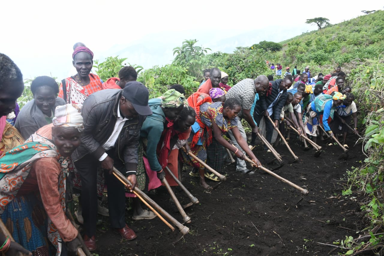 West Pokot Director of Peace,Rev,Jackson Alukusia (front third from left) joined hands with local communities to construct a vital road linking Chepkogogh location in West Pokot County to Kipchumwa location in Marakwet East Constituency, Elgeyo Marakwet County. Photo/Anthony Melly