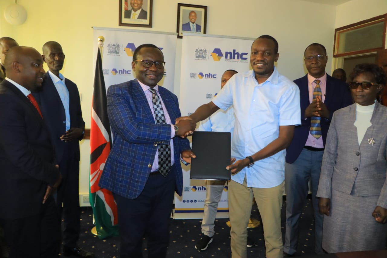 NHC Board Chairman, Yusuf Chanzu, (second left) hands over housing schemes’ documents to Kisii Governor, Simba Arati, (2nd right) during a ceremony at the Governor’s offices in Kisii.