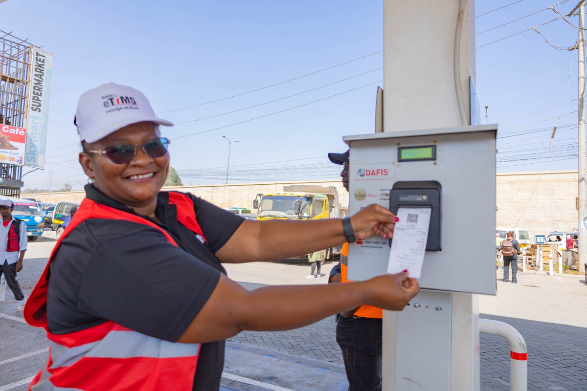 A Kenya Revenue Authority official demonstrates how the eTIMS receipts displays after purchase at the one of the on boarded Be Energy station in Ruai, Nairobi