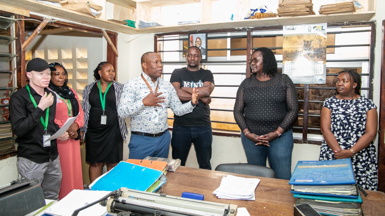 National Land Information Management System Director Ms. Monica Obongo (right) receives a briefing from the Kwale Land Registrar Steve Mokaya (fourth from left) during her visit to Kwale County. PHOTO: GRACE WALEGHWA