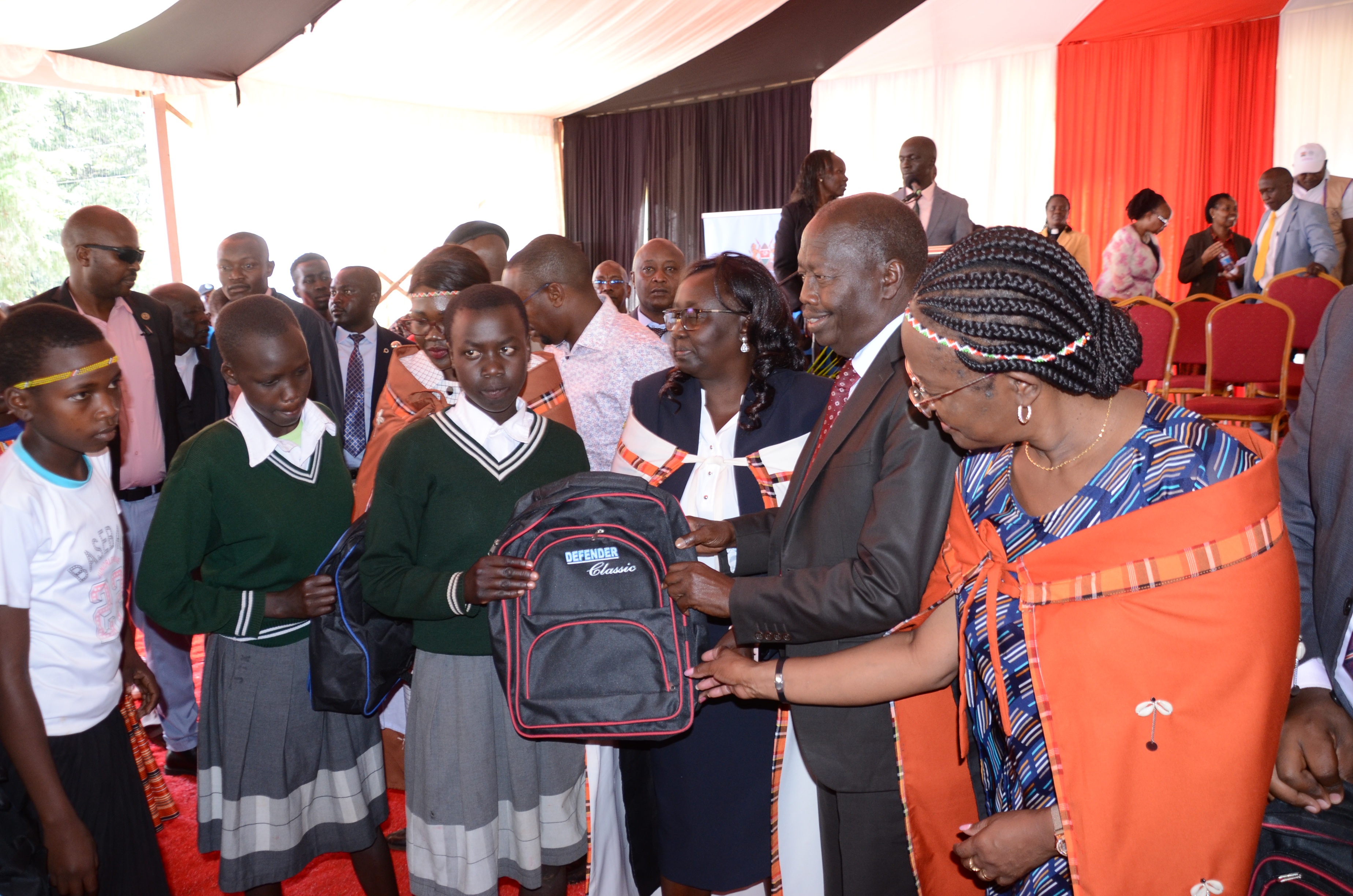 Cabinet Secretary (CS) for Gender, Culture and Children’s Services Hanna Cheptumo handing over a dignity kit with Baringo Governor Benjamin Cheboi to Junior Secondary School students during a ceremony held at Kabarnet School for deafblind.