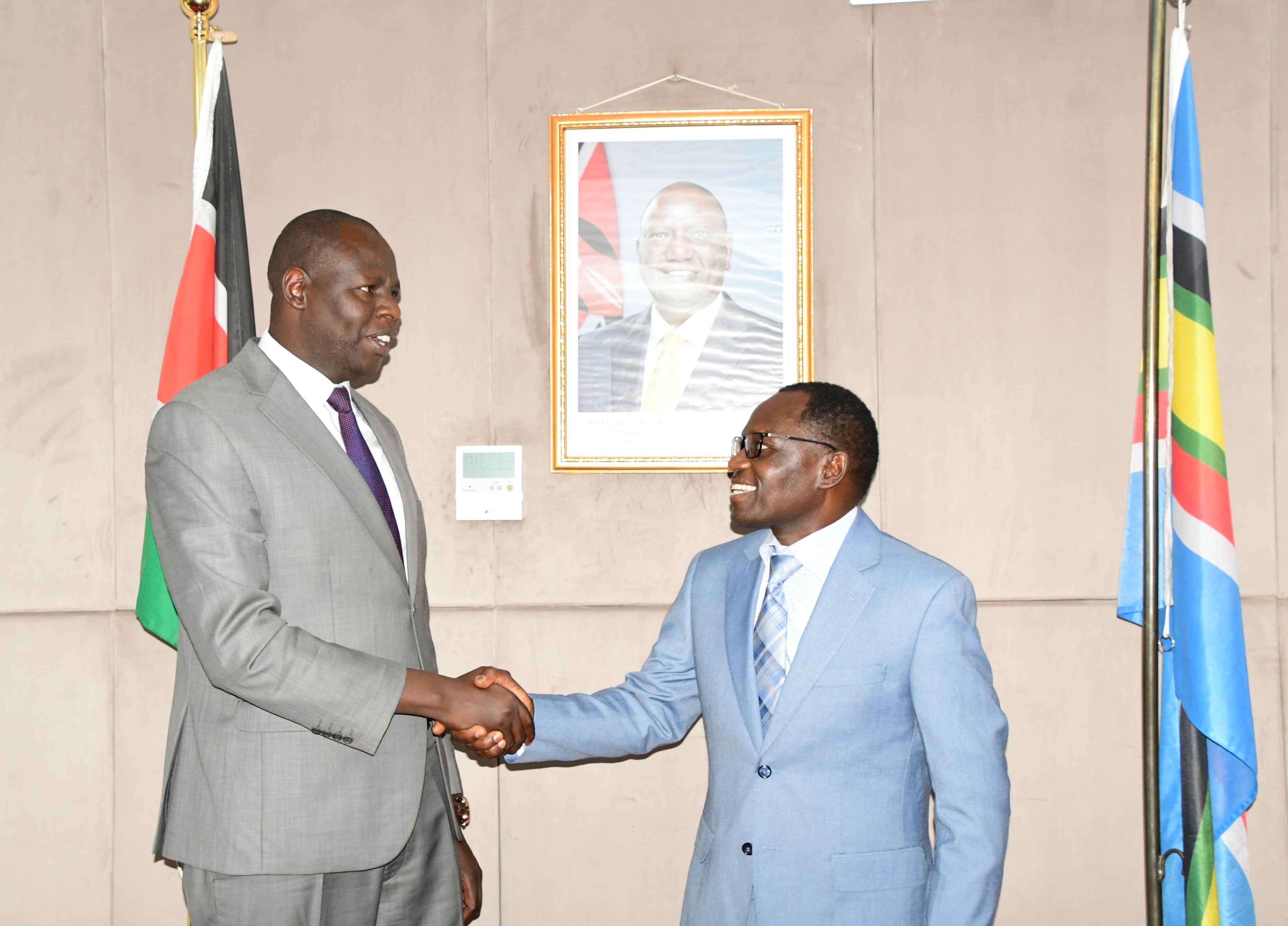 Principal Secretary, State Department for Broadcasting and Telecommunication, Stephen Isaboke, have a light moment with Josphat Lowoi, the Secretary, Minorities and Marginalized Affairs Unit at the Executive Office of the President,