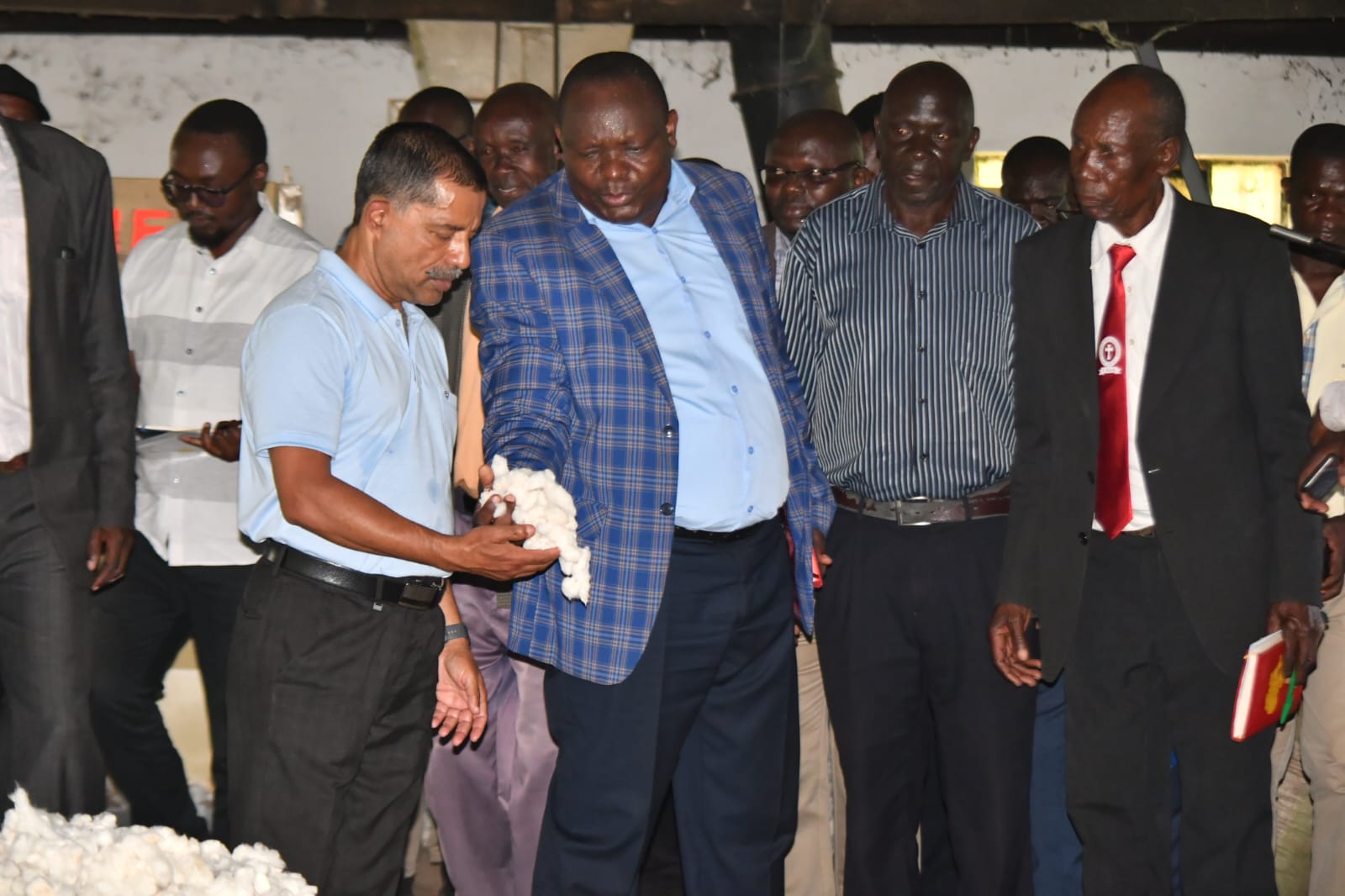 State Department for Cooperatives Secretary Administration Amos Mariba (in checked blue  court) during the Luanda Ginnery site handing over ceremony to the contractor. PHOTOS BY CHRIS MAHANDARA