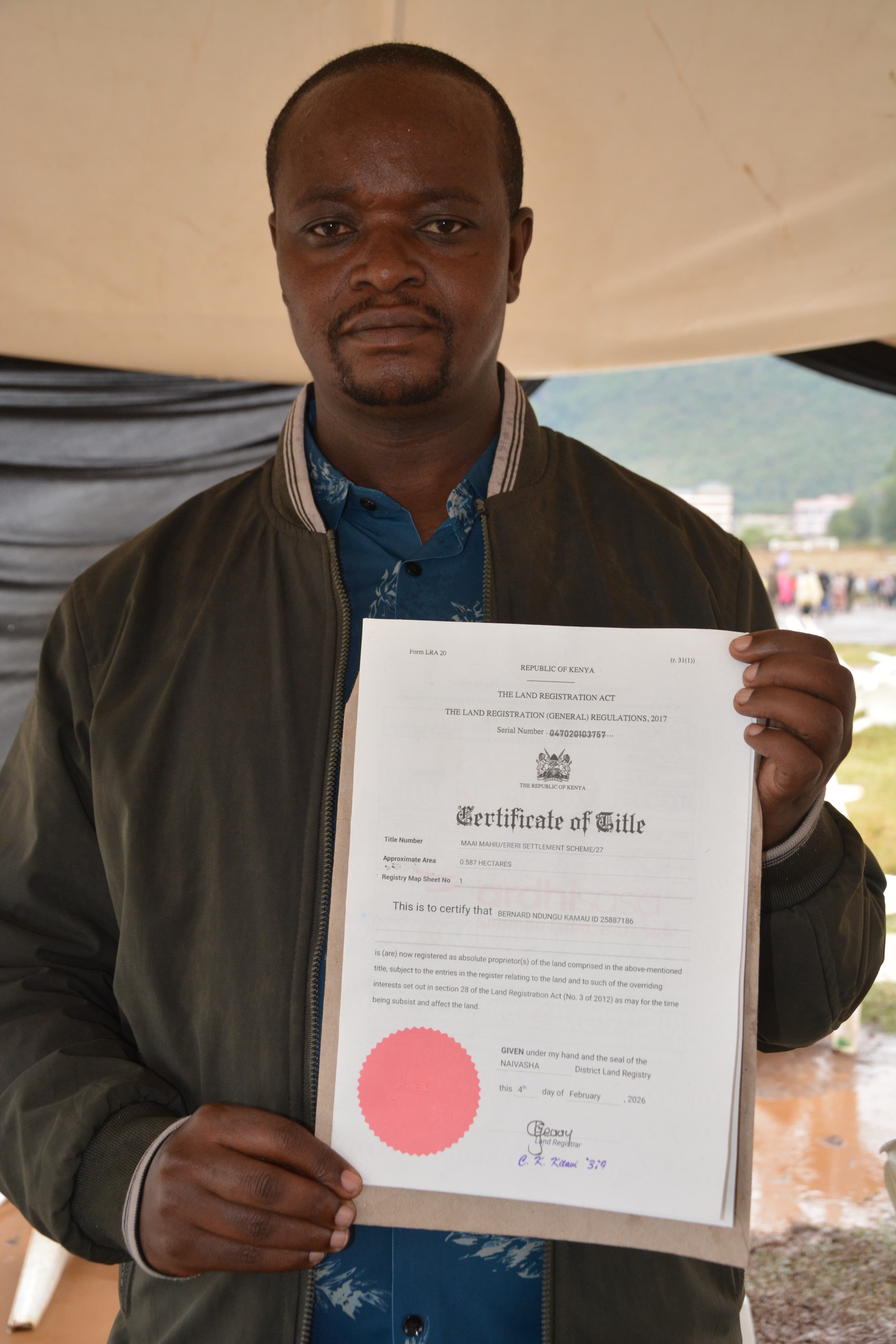  Bernard Kamau, who lost two of his sons in the Mai Mahiu flood incident on April 29, 2024, displays his title deed issued by the government to 105 land owners after securing 230 acres in the Longonot area of Naivasha for resettlement. PHOTO BY ERASTUS GICHOHI