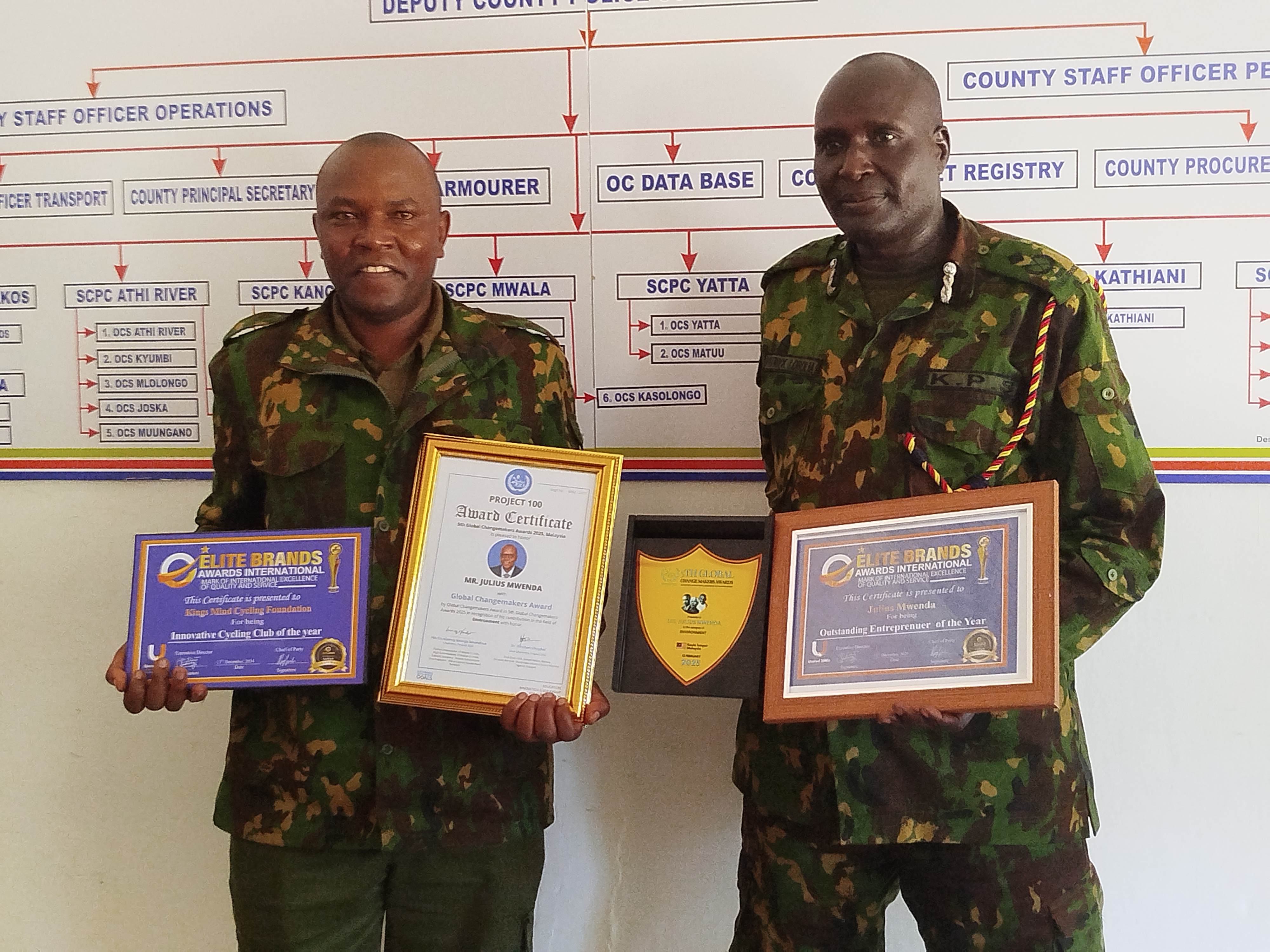 Julius Mwenda the Police Environmentalist and Cyclist from Machakos as he showcases his awards together with his boss County Commander Patrick Lobolia at Machakos Police station. Photo by Anne Kangero