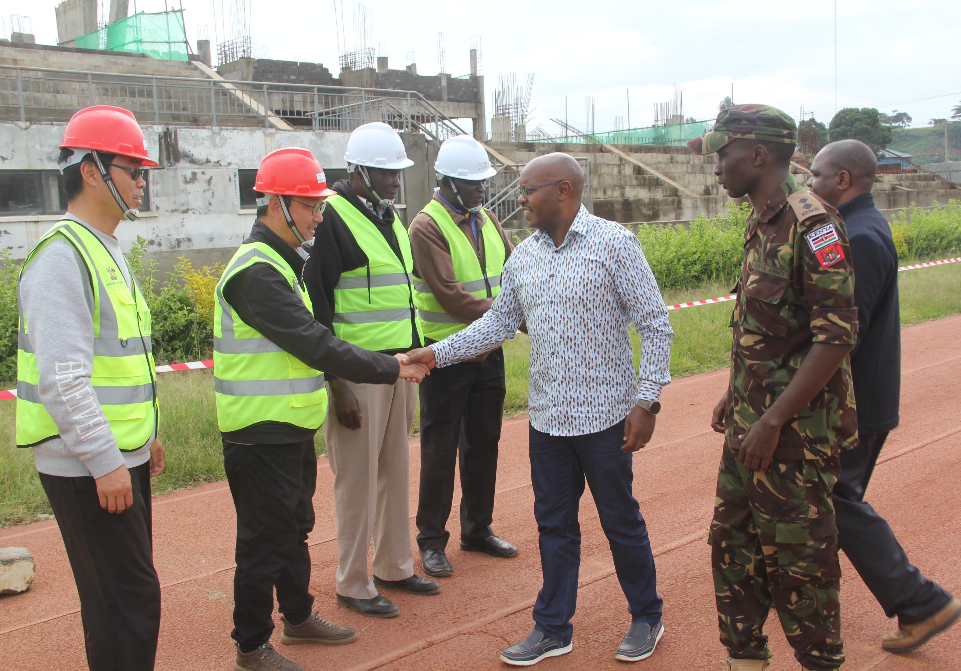 The Defence PS, Dr. Patrick Mariru (c), meets the contractors during the inspection visit to Kipchoge Keino Stadium, Eldoret, Uasin Gishu County