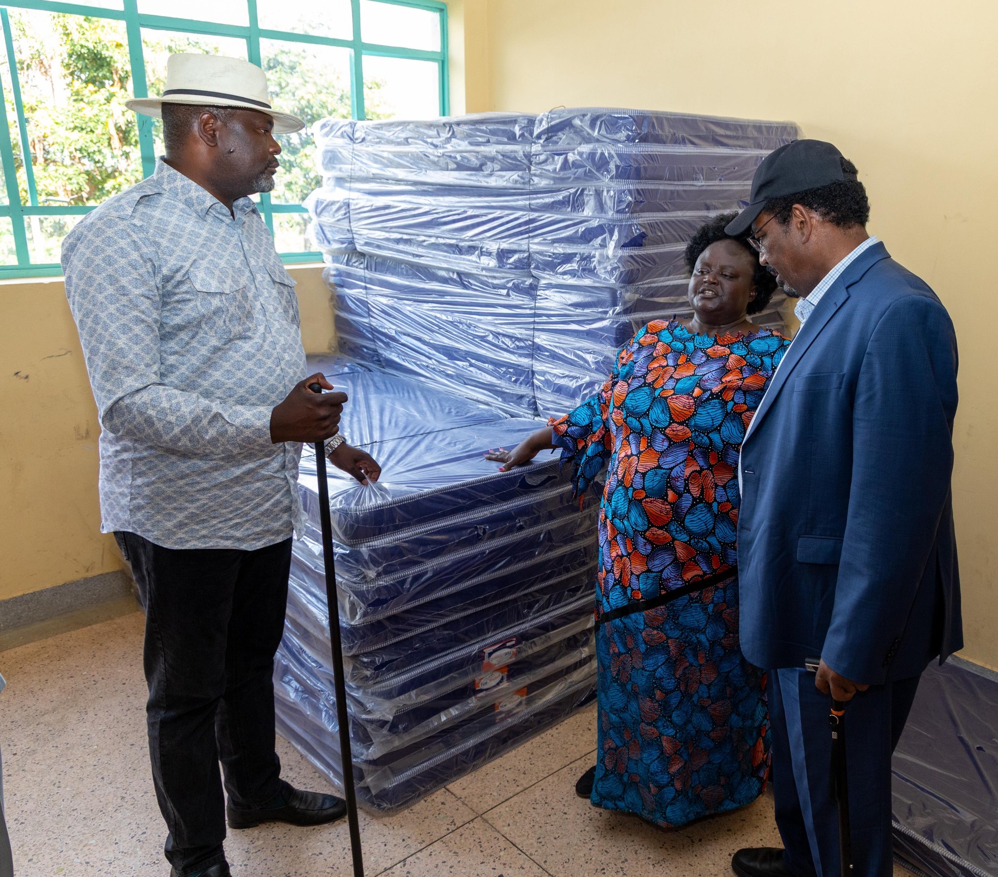 Dadaab MP Farah Maalim, Woman Representative Joyce Osogo Bensuda and Public Service and Capital Development Cabinet Secretary Geofrey Ruku stand beside mattresses to be distributed to vulnerable families courtesy of the government 