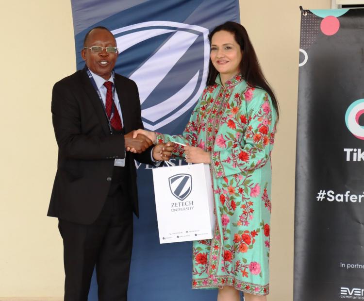 Zetech Vice Chancellor Prof Njenga Munene gifts the Head of Public Policy Programs at TikTok for the Middle East, Africa, Turkiye, Pakistan & South Asia Ms. Zara Higgs.