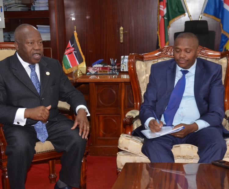 The Executive Secretary for ICGLR Ambassador Joao Samuel Caholo (l) with Mining Principal Secretary Elijah Mwangi (r) during their meeting in Nairobi.