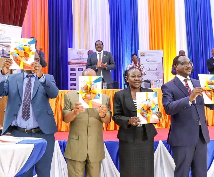 Education Cabinet Secretary Julius Ogamba on the right followed by Principal Secretary State Department for TVET Dr. Esther Muoria displaying TVET assessment results.