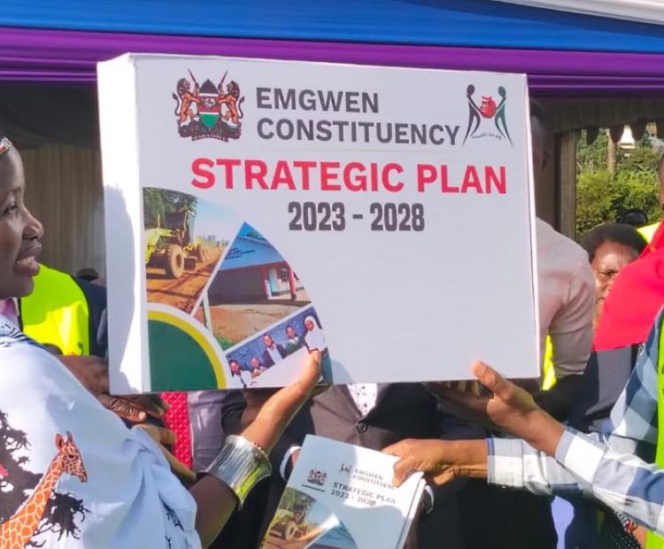 PS for the State Department of Micro Small and Medium Enterprises (MSMEs) Development, Susan Mang’eni and area MP Josses Lelmengit display the Emgwen Constituency Strategic Plan 2023_2028 after the launch at Eliud Kipchoge Showground in Kapsabet.