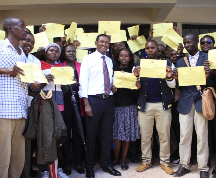 Cabinet Secretary for Labor and Social Protection Dr.Alfred Mutua with some of the residents who have been successfully recruited for various overseas job at the Machakos Institute for the blind. Photo/Allan Maina.