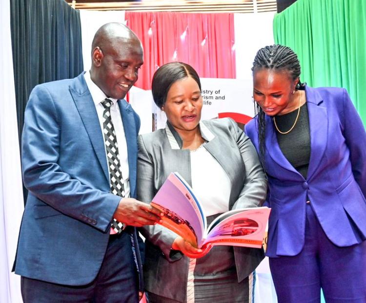 The Cabinet Secretary for Tourism and Wildlife, Hon. Rebecca Miano (centre), The Principal Secretary State Department for Tourism, John Ololtuaa (left), and the Principal Secretary State Department for Wildlife, Silvia Museiya (right), going through the Strategic Plan..