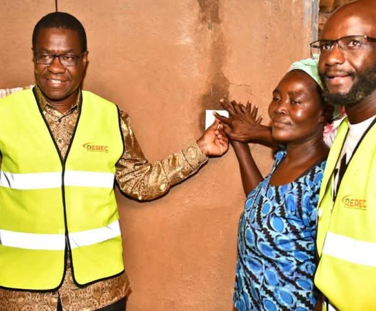 Energy Cabinet Secretary, Opiyo Wandayi, flanked by Alego - Usonga MP Samwel Atandi (R) switches on power in one of the houses at Obambo Kadhai village.