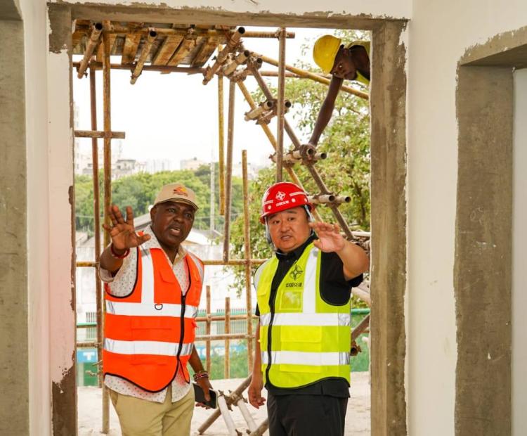 The Kenya Railway Corporation Managing Director, Mr Philip Maingi (L) and a constructor inspecting construction works at the Mombasa Central Railway Station.