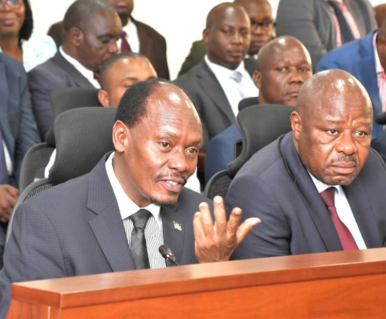Outgoing Principal Secretary for Broadcasting and Telecommunications Prof Edward Kisiangáni (left) with MICDE CS William Kabogo (centre) when they appeatred before the Senate Committee in Parliament. 