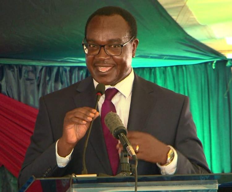 Education Cabinet Secretary Julius Ogamba addressing parents and students at Mary Hill Girls in Thika during a prize giving day.