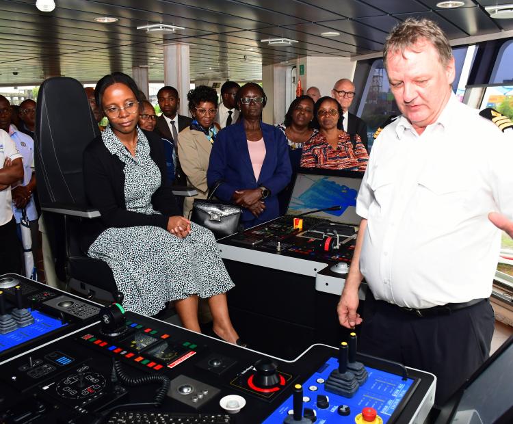 Principal Secretary (PS) for Blue Economy Betsy Njagi (seated) is taken through a brief aboard Dr. Fridtjof Nansen’s research marine vessel when it docked at the Mbaraki Wharf, Mombasa. 