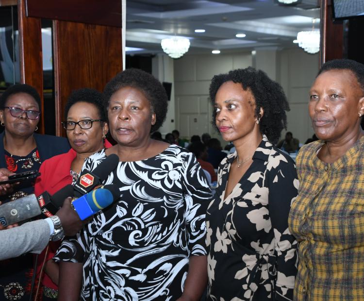 Chairperson of the Technical Working Group on Gender  Based Violence (GBV) Including Famicide, Nancy Baraza  (center) addresses members of the press at Kenyatta  International Convention Center, Nairobi during a Plenary  Meeting for Technical Working Group on Gender-Based  Violence (GBV) Including Femicide. PHOTOS BY BONFACE  MALINDA/KNA