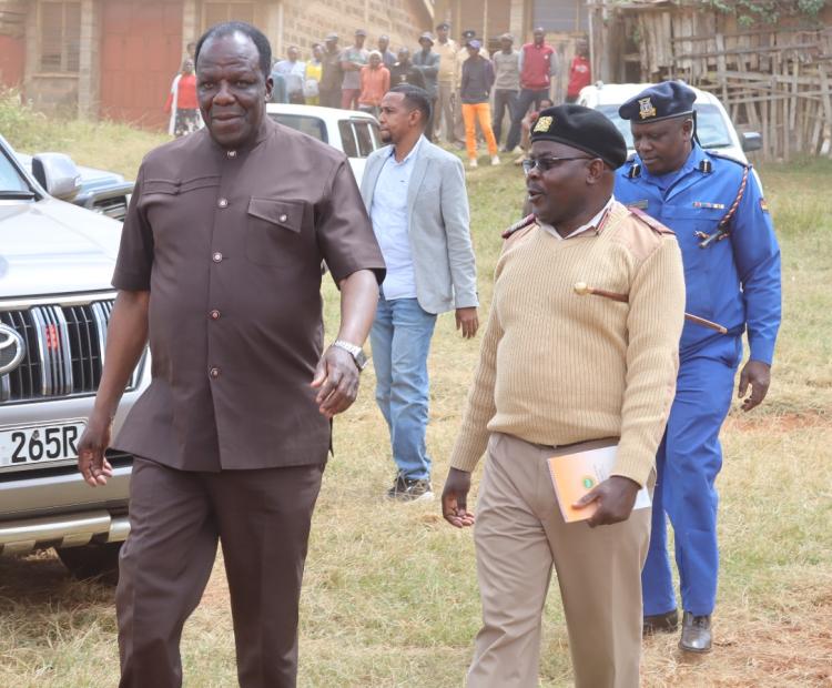 Cooperatives Cabinet Secretary, Wycliffe Oparanya,  is escorted by Mbooni West DCC, Stanlaus Apwoka, at  Kikima town, where he addressed farmers