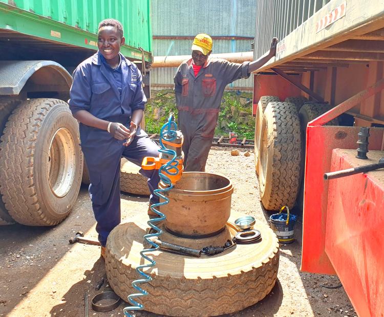 Miriam Chepchumba takes a rest after successfully fixing a faulty truck tyre in her garage. PHOTO/JOYCE JEPKOSGEI
