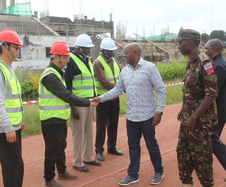 The Defence PS, Dr. Patrick Mariru (c), meets the contractors during the inspection visit to Kipchoge Keino Stadium, Eldoret, Uasin Gishu County
