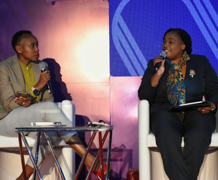 Secretary ICT E-Government-In-Charge of Systems in the Ministry of Information, Communications and the Digital Economy, Ms. Mary Kerema (Right), speaking during the Seamless East Africa 2025 event held at the Kenyatta International Convention Centre in the Company of Ms. Monicah Ndungu, Chief Operating Officer, Nation Media Group.
