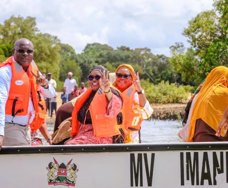 .From left Kwale County Executive Committee Member for Agriculture Roman Shera, Governor Fatuma Achani and County Executive for Environment Saumu Beja on board one of the four fiberglass boats that were issued to local fisherfolks in Msambweni sub county.