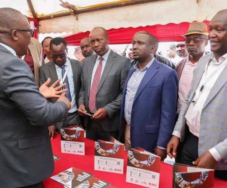 Investments, Trade and Industry CS Lee Kinyanjui, interacts with MSME exhibitors and listens to their presentations during the opening of the Investment Summit at Kiprugut Chumo Stadium in Kericho Town.