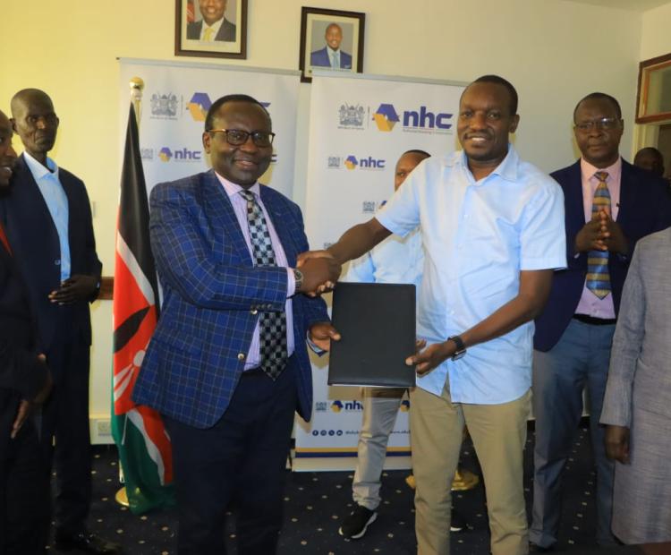 NHC Board Chairman, Yusuf Chanzu, (second left) hands over housing schemes’ documents to Kisii Governor, Simba Arati, (2nd right) during a ceremony at the Governor’s offices in Kisii.