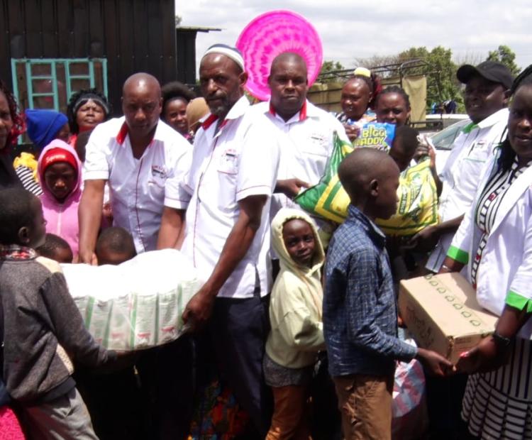 Cotton farmers from Kwale County receive pesticides from officials from a Thika Based Textile company, Thika Clothes Mill.