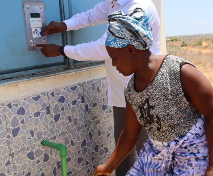  National Drought Management Authority (NDMA) Chief Executive Officer Aden Hared draws water from the automated water dispensing (ATM) kiosk at Roka in Mackinnon Road Ward, Samburu Sub-County, Kwale County, during inspection of the Taru–Roka–Egu–Kwa Kalinga Water Pipeline Extension Project.