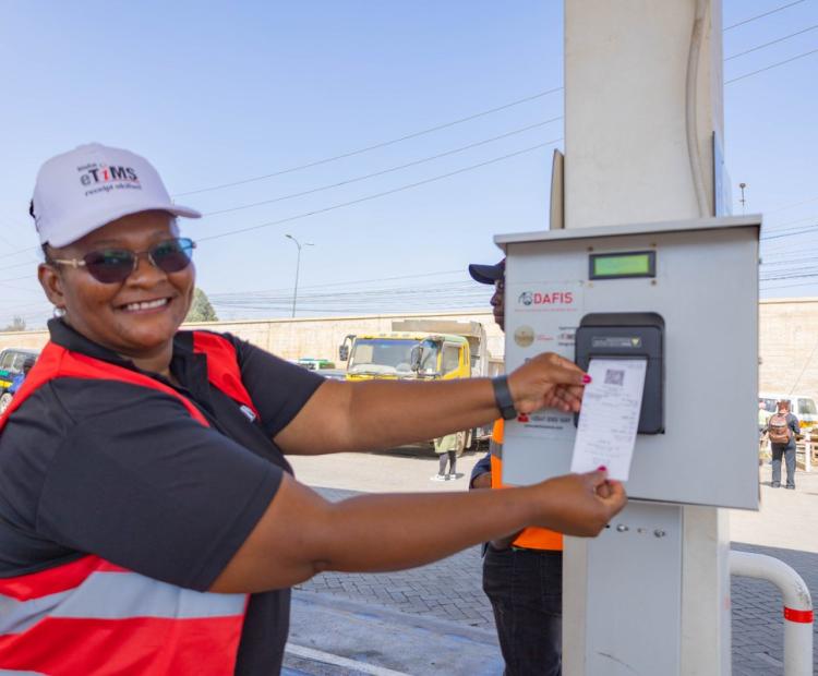 A Kenya Revenue Authority official demonstrates how the eTIMS receipts displays after purchase at the one of the on boarded Be Energy station in Ruai, Nairobi