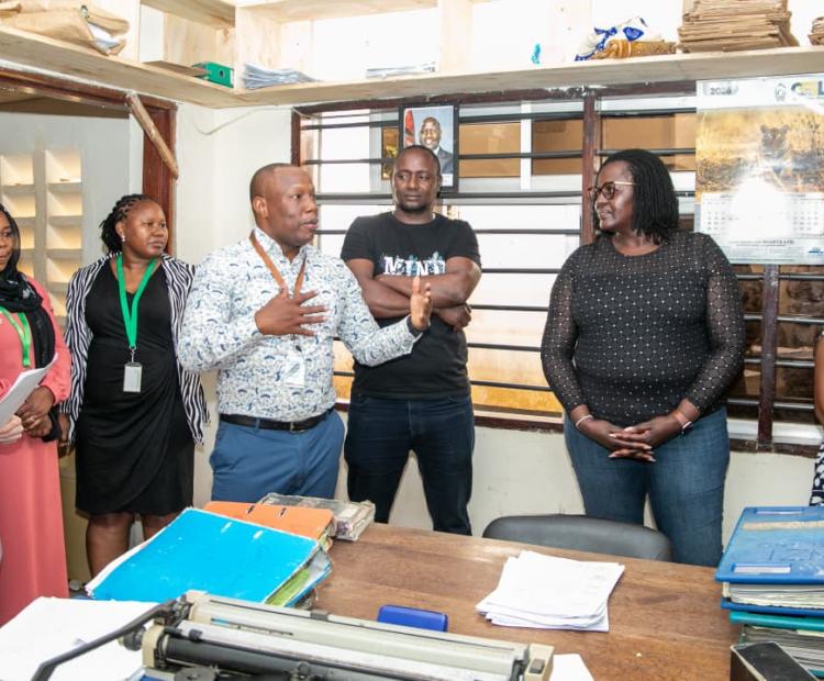 National Land Information Management System Director Ms. Monica Obongo (right) receives a briefing from the Kwale Land Registrar Steve Mokaya (fourth from left) during her visit to Kwale County. PHOTO: GRACE WALEGHWA