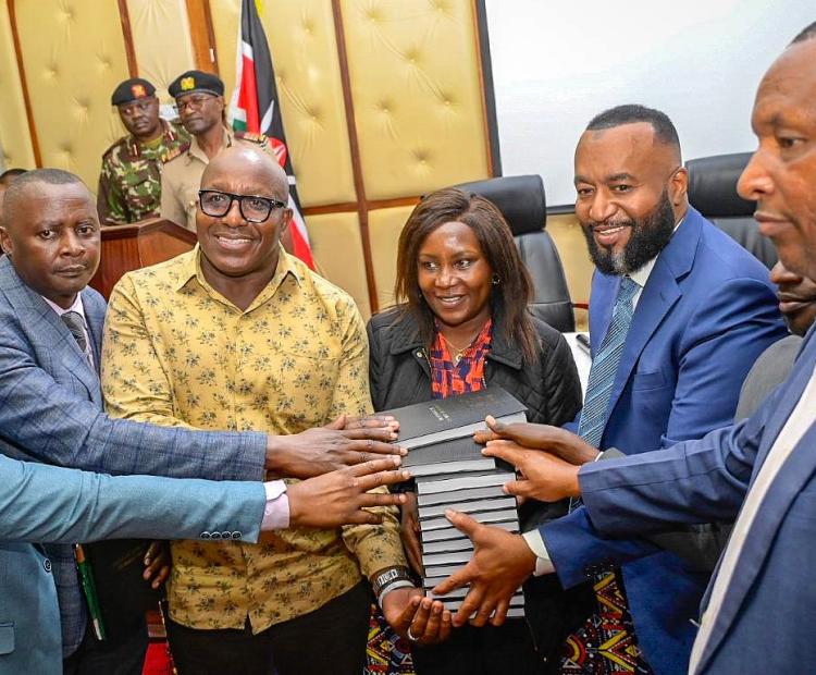 . Cabinet Secretary (CS) for Mining, Blue Economy and Maritime Affairs Ali Hassan Joho (third from right) handing over copies of Mining Act to Embu County officials led by Governor Cecily Mbarire (next to him)